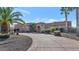 Impressive exterior of a single-story house with a stone facade and palm trees at 2625 W Desert Hills Dr, Phoenix, AZ 85086