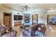 Spacious living room with a stone fireplace and a large TV at 2625 W Desert Hills Dr, Phoenix, AZ 85086