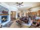 Cozy living room features a stone fireplace and comfortable seating at 2625 W Desert Hills Dr, Phoenix, AZ 85086
