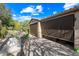 Outdoor kitchen and patio with seating area and retractable shade at 27434 N 130Th Dr, Peoria, AZ 85383