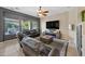 Living room with leather furniture, electric fireplace, and large windows at 27434 N 130Th Dr, Peoria, AZ 85383