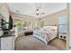 Bright main bedroom with a ceiling fan and plenty of natural light at 27434 N 130Th Dr, Peoria, AZ 85383