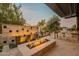 Back patio with a fire pit, decorative stone wall, and built in grill area perfect for outdoor entertaining at 290 E Tangerine Path, Queen Creek, AZ 85140