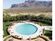 Circular pool with lounge chairs and mountain views at 3205 S Ponderosa Dr, Gold Canyon, AZ 85118