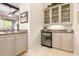Convenient wet bar with glass-front cabinetry and wine cooler at 3205 S Ponderosa Dr, Gold Canyon, AZ 85118