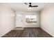 Living room with hardwood floors, a ceiling fan and window at 3719 W Acoma Dr, Phoenix, AZ 85053