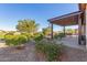 Landscaped backyard with pergola and pathway at 41688 W Cribbage Rd, Maricopa, AZ 85138