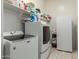 Laundry room with washer, dryer, and extra storage at 41688 W Cribbage Rd, Maricopa, AZ 85138