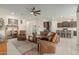 Open concept living area with leather furniture and kitchen views at 41688 W Cribbage Rd, Maricopa, AZ 85138