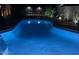 Illuminated pool at night with colorful lighting at 514 E Gabrilla Dr, Casa Grande, AZ 85122