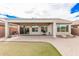 A backyard with a covered patio features desert landscaping and stone pavers at 6546 W Georgetown Way, Florence, AZ 85132