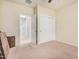 A carpeted bedroom features a ceiling fan and a closet with sliding doors at 6546 W Georgetown Way, Florence, AZ 85132