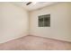 Carpeted bedroom featuring a ceiling fan and a large window with blinds at 6546 W Georgetown Way, Florence, AZ 85132