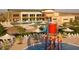 Resort-style community pool area with water features, lounge chairs, and lush landscaping at 6546 W Georgetown Way, Florence, AZ 85132