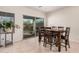 Cozy dining area with tile flooring, a sliding glass door to the patio, and a wooden table at 6546 W Georgetown Way, Florence, AZ 85132