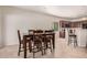 Cozy dining area adjacent to kitchen features modern dark wood table set and tile flooring at 6546 W Georgetown Way, Florence, AZ 85132