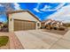 Charming single-story home with a large driveway, desert landscaping, and a two-car garage at 6546 W Georgetown Way, Florence, AZ 85132