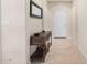 Bright hallway featuring tile flooring, a decorative table, and a mirror enhancing the space at 6546 W Georgetown Way, Florence, AZ 85132