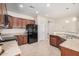 Well-lit kitchen with stainless steel appliances, granite countertops, and abundant cabinet space at 6546 W Georgetown Way, Florence, AZ 85132