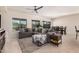 Bright living room featuring a large sectional sofa, tile floors, and a view of the dining area at 6546 W Georgetown Way, Florence, AZ 85132