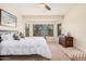 Comfortable main bedroom featuring carpet flooring, a bay window, and a cozy ambiance at 6546 W Georgetown Way, Florence, AZ 85132