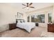 Bright main bedroom with a large window, carpet flooring, and ample space for relaxation at 6546 W Georgetown Way, Florence, AZ 85132