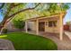 Backyard with covered patio, artificial turf, and landscaping at 7046 W Mercer Ln, Peoria, AZ 85345