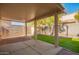 Landscaped backyard with covered patio and artificial turf at 7046 W Mercer Ln, Peoria, AZ 85345