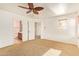 Bright bedroom with ceiling fan and access to bathroom at 7046 W Mercer Ln, Peoria, AZ 85345