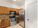Well-equipped kitchen with stainless steel appliances and wood cabinets at 7046 W Mercer Ln, Peoria, AZ 85345