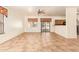Living room with tile floors and sliding glass doors to backyard at 7046 W Mercer Ln, Peoria, AZ 85345