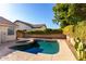 Inviting kidney shaped pool with surrounding landscaping at 7928 E Obispo Ave, Mesa, AZ 85212