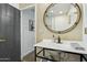Contemporary bathroom with a stylish vanity and large round mirror at 8214 E Northland Dr, Scottsdale, AZ 85251