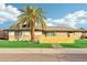 Ranch style home with artificial turf, yellow fence, and mature palm tree at 8214 E Northland Dr, Scottsdale, AZ 85251