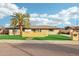 Mid-century modern home with artificial turf lawn and yellow wood fence at 8214 E Northland Dr, Scottsdale, AZ 85251