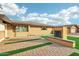 House exterior with brick fireplace and paved walkway at 8214 E Northland Dr, Scottsdale, AZ 85251