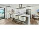 Bright kitchen boasts white cabinets, quartz countertops, and island seating at 8214 E Northland Dr, Scottsdale, AZ 85251