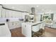 Modern kitchen with white cabinets, quartz countertops, and a large island at 8214 E Northland Dr, Scottsdale, AZ 85251