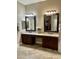Bathroom vanity with dual sinks, granite counters, and decorative mirrors at 861 E Toledo St, Gilbert, AZ 85295