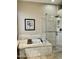 Luxurious bathroom with soaking tub, glass-enclosed shower, and tile accents at 861 E Toledo St, Gilbert, AZ 85295