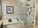 Luxurious bathroom with soaking tub, glass-enclosed shower, and tile accents at 861 E Toledo St, Gilbert, AZ 85295