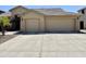 Tan home featuring a two-car garage, desert landscaping, and a tile roof, perfect for low-maintenance living at 861 E Toledo St, Gilbert, AZ 85295