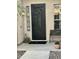Close up of custom security door with welcome mat and bench at 861 E Toledo St, Gilbert, AZ 85295