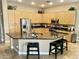 A modern kitchen with a large island, stainless steel appliances, and light wood cabinets at 861 E Toledo St, Gilbert, AZ 85295