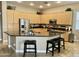 A modern kitchen with a large island, stainless steel appliances, and light wood cabinets at 861 E Toledo St, Gilbert, AZ 85295