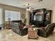 Spacious living room with tile floors, comfortable seating, ceiling fan and large entertainment center at 861 E Toledo St, Gilbert, AZ 85295