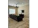 Cozy living room featuring a large sofa, ceiling fan, and a modern TV setup for entertainment at 861 E Toledo St, Gilbert, AZ 85295