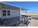 Covered patio area with two bikes and access to the home at 8700 E University Dr # 2405, Mesa, AZ 85207