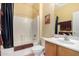 Clean bathroom with tub, shower, and wood vanity at 878 E Cherry Hills Dr, Chandler, AZ 85249