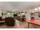 Living room with brown sofas and a large TV, open concept at 878 E Cherry Hills Dr, Chandler, AZ 85249